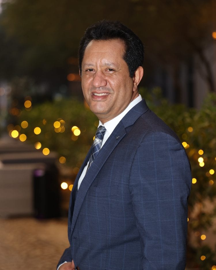 Portrait of Ashraf Effat Amer, Founder and Managing Director of AHSAN Advisory, wearing a navy suit